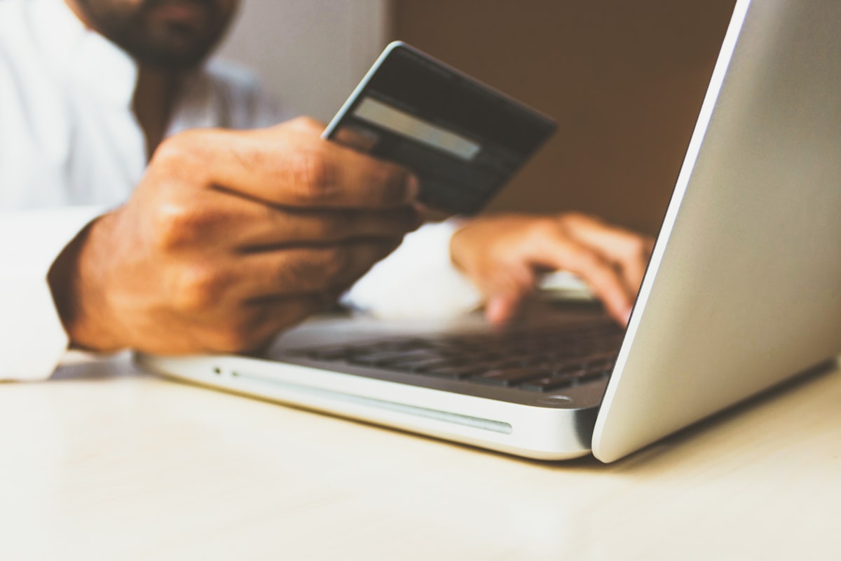 Shopping cart page on a laptop showing payment method logos and security badges at checkout